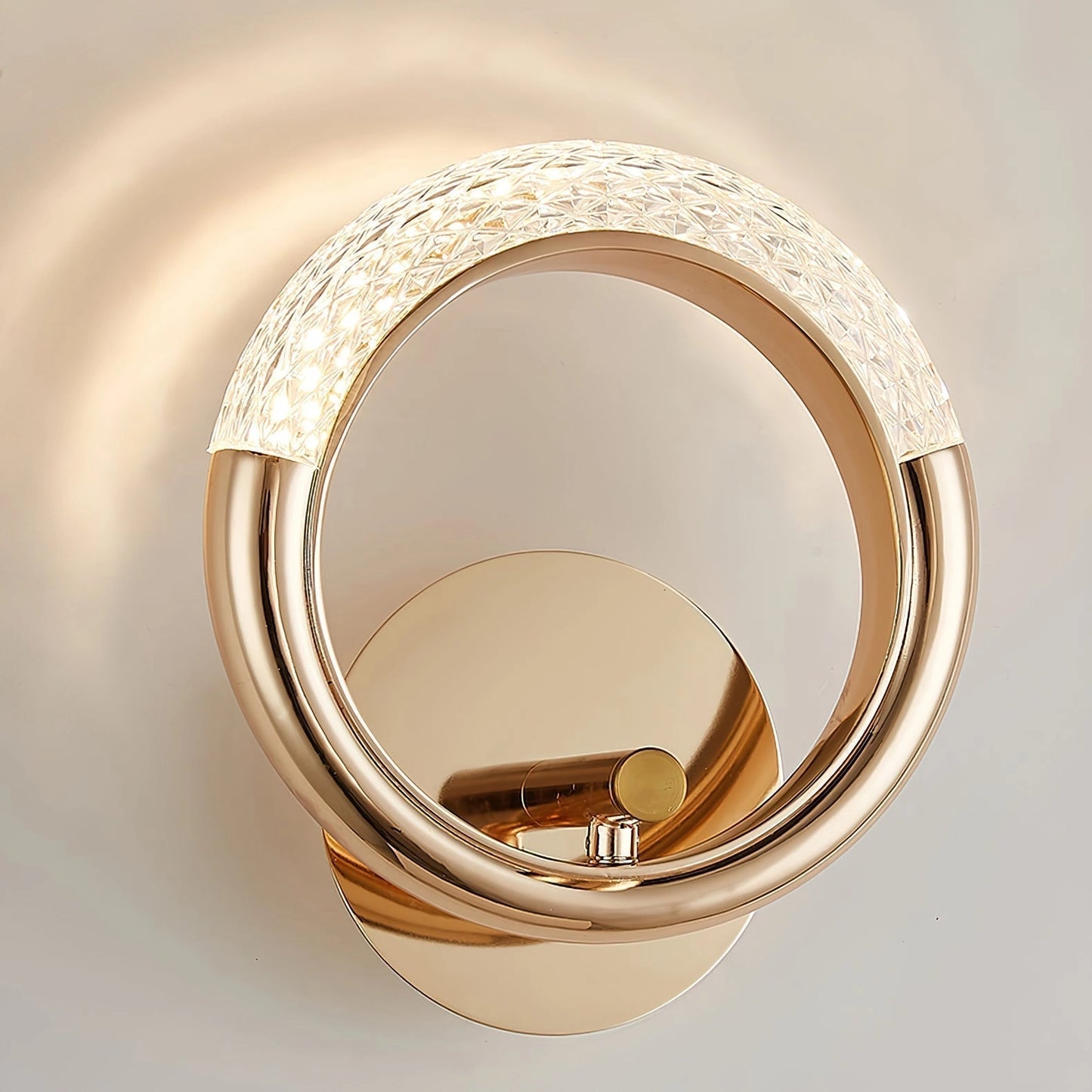 Luxurious metallic rotatable wall lamp with an adaptable angle, featuring a sleek design and circular elements.