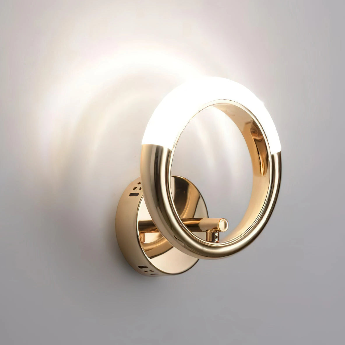 Luxurious metallic wall lamp with an adaptable angle and rotatable design, mounted on a wall.