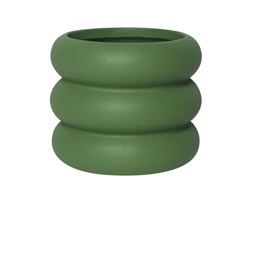 Large green ceramic round plant pot on a table.
