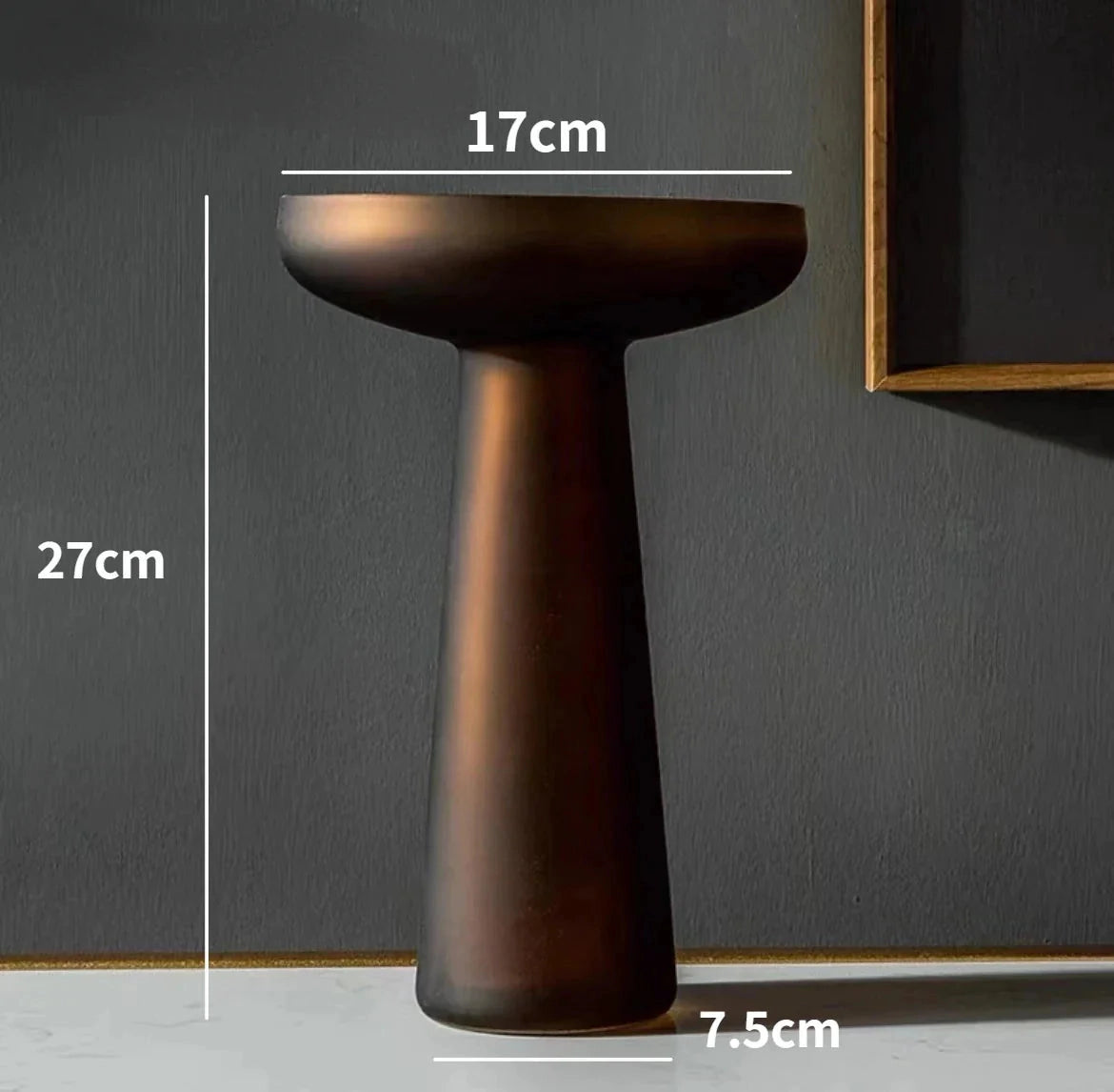 A coffee-colored frosted glass vase displayed on a wooden table.