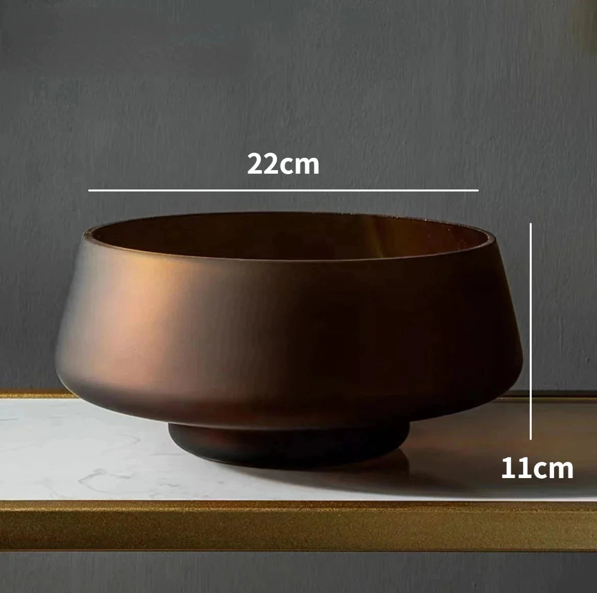 Coffee-colored frosted glass vase placed on a wooden table.