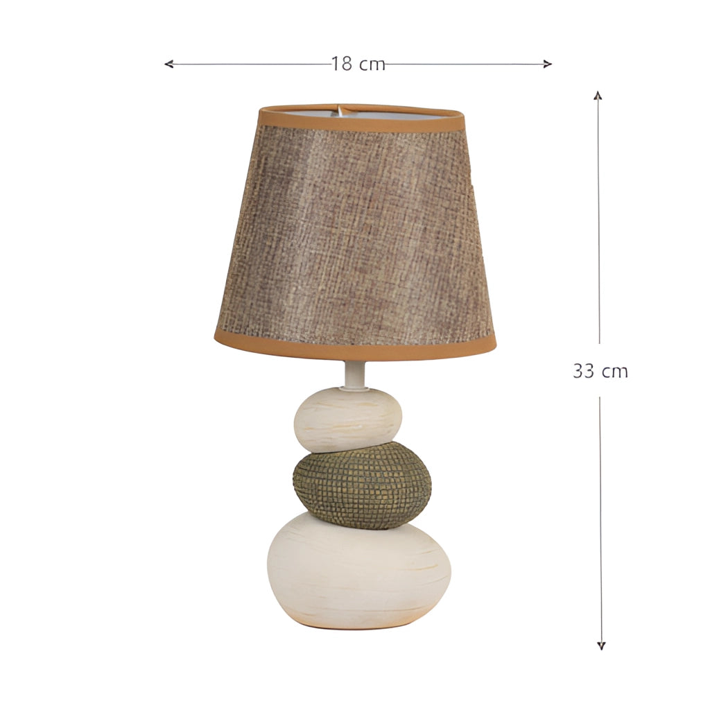 Contemporary fabric lampshade on a wooden desk or nightstand with a metal base and modern design.