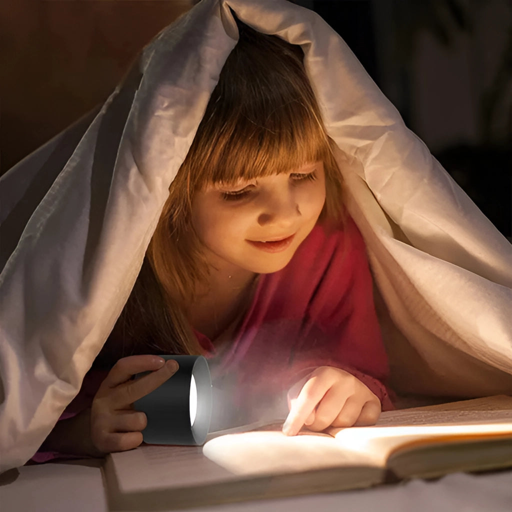 A child with long hair wearing a dress, smiling and using their hand to adjust the cordless LED wall lamp with adjustable brightness and color modes.