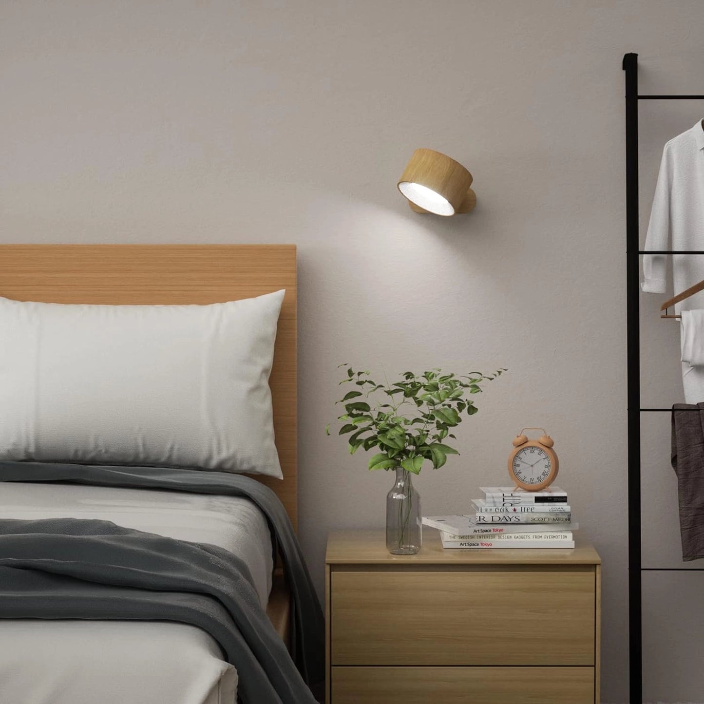 Cordless LED wall lamp with adjustable brightness and color modes mounted on a grey wall in a modern living room with wooden floors, a plant, and contemporary furniture.