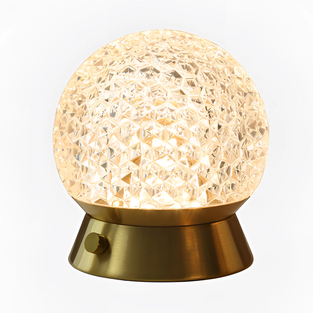 Modern cordless rechargeable LED table lamp with dimmable light on a wooden surface, surrounded by indoor plants and metal decor pieces.