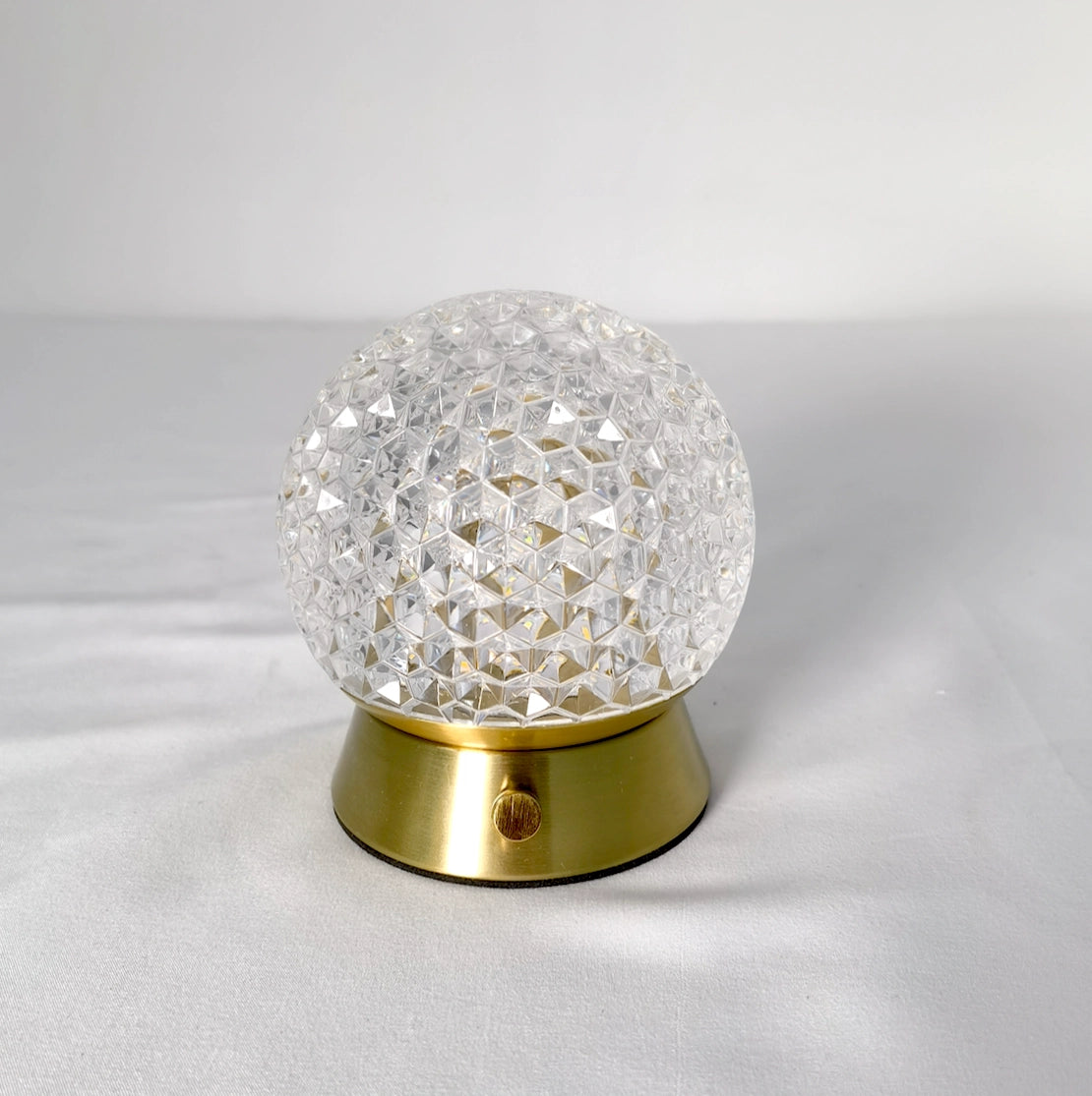 Cordless rechargeable LED table lamp with a modern design, featuring a dimmable light, silver metal base, and a clear glass shade.