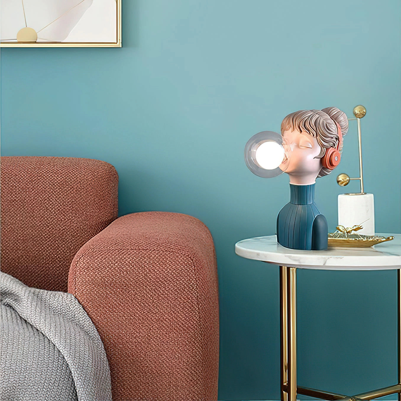 Chic minimalist desk lamp with an orange-green resin base, placed on a table, illuminating a stylish interior space.