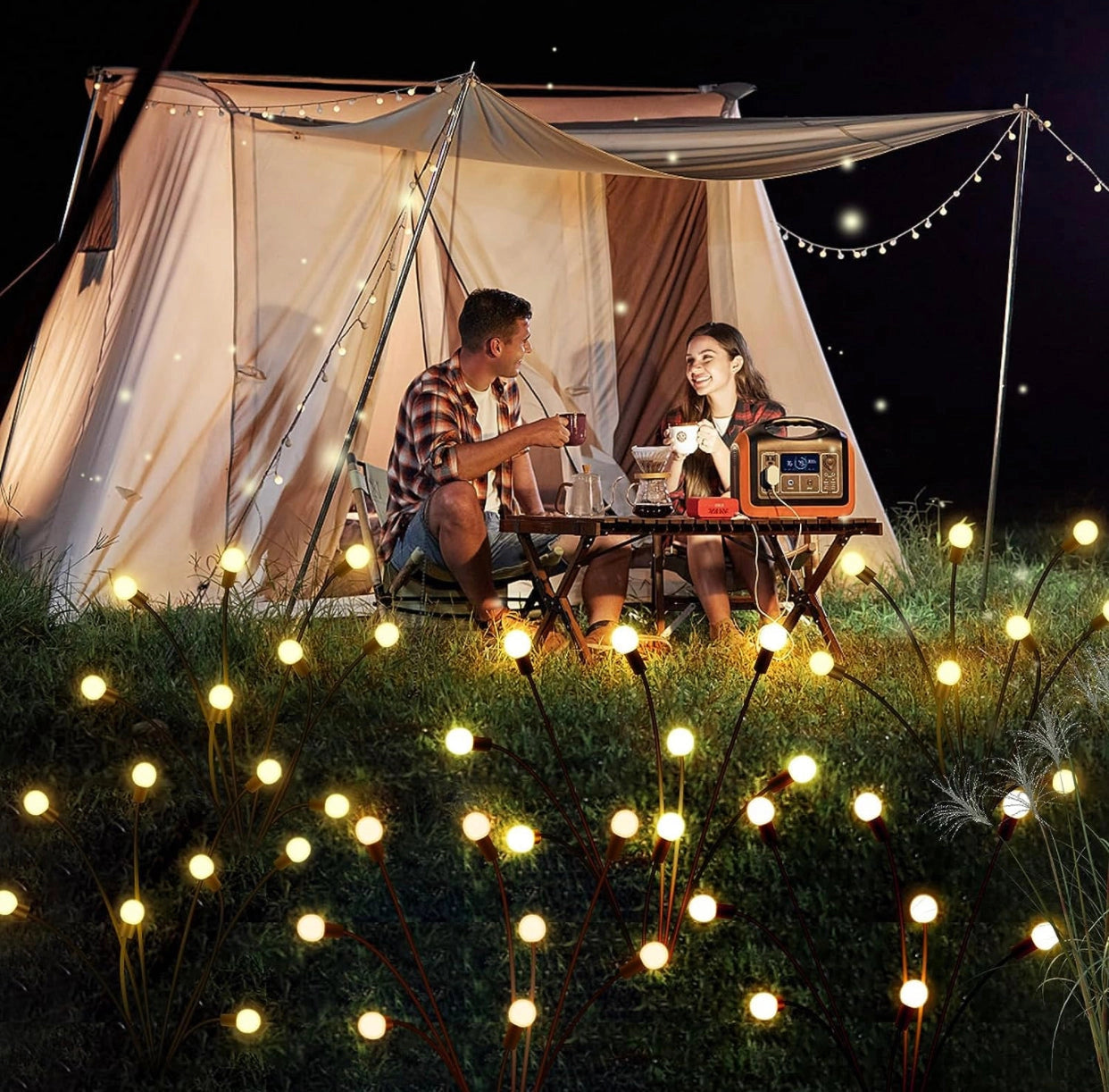 Enhanced Solar Powered 8 LED Lights Quad Pack illuminating a tent during an outdoor event with people enjoying music and entertainment.