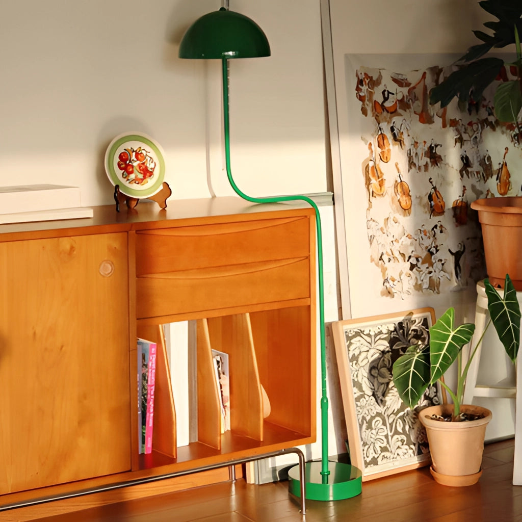 Floor lamp with tricolor light in green, white, and natural wood, next to a potted houseplant in a modern interior setting.