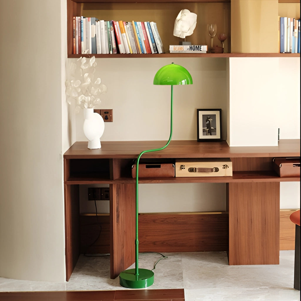 Floor lamp with organic inspiration, showcasing quality craftsmanship, featuring green, white, and tricolor light, placed next to a table and bookcase in a well-designed interior space.