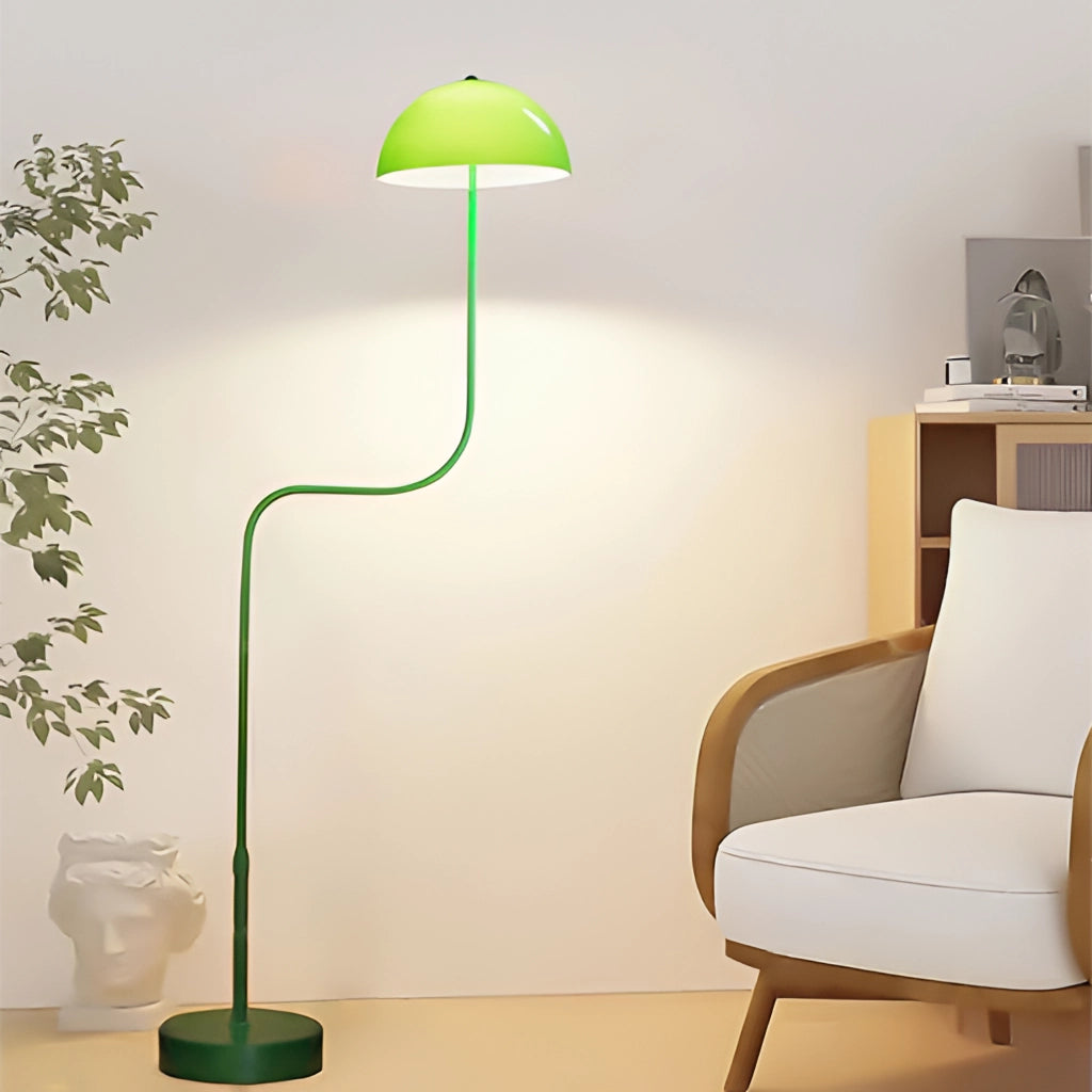 Floor lamp with organic inspiration, quality craftsmanship, featuring a green, white, and tricolor light, standing on wooden flooring near a chair and plant.