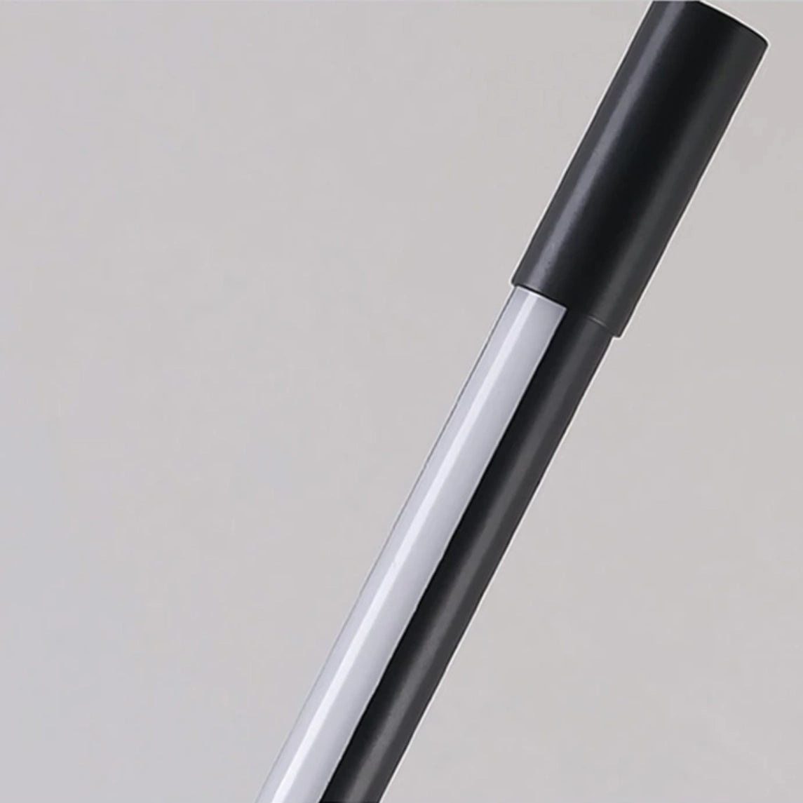 A stylish and modern floor lamp with a sleek metal and wood design, suitable for versatile lighting in any avant-garde office or home setting.