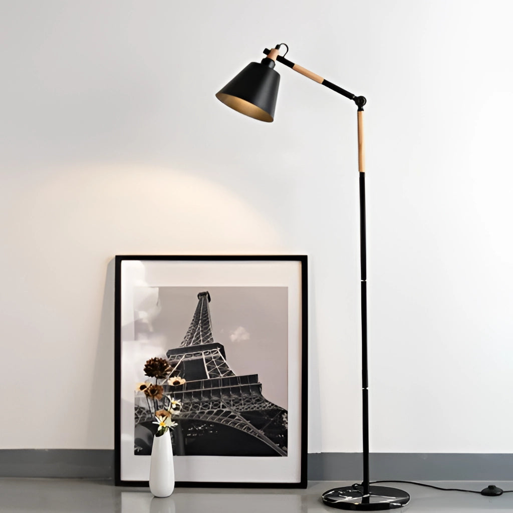 A floor lamp with a marble base and versatile lighting, placed near a picture frame and other decorative items. The lamp features a sleek metal design, casting soft light in the room.