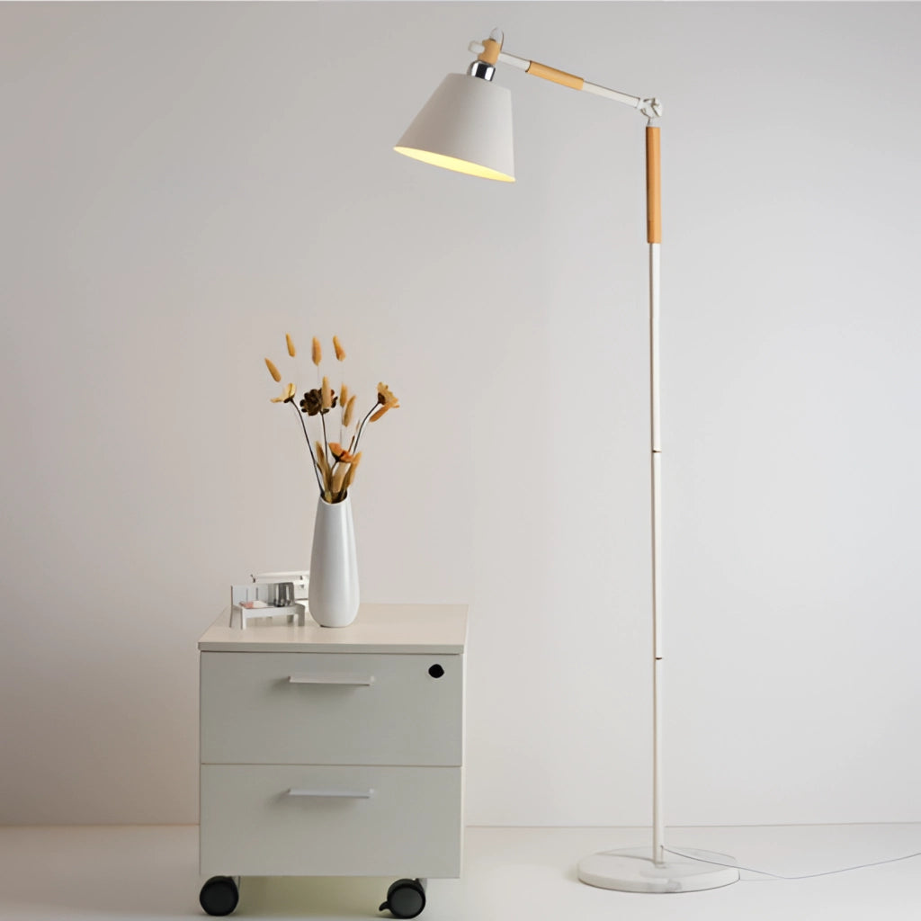 Floor lamp with marble base and versatile lighting next to a dresser with plants and flowers on top.