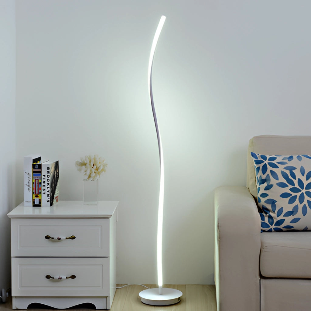 Silver floor lamp with remote control, featuring three adjustable light temperatures, standing beside a grey wooden dresser.