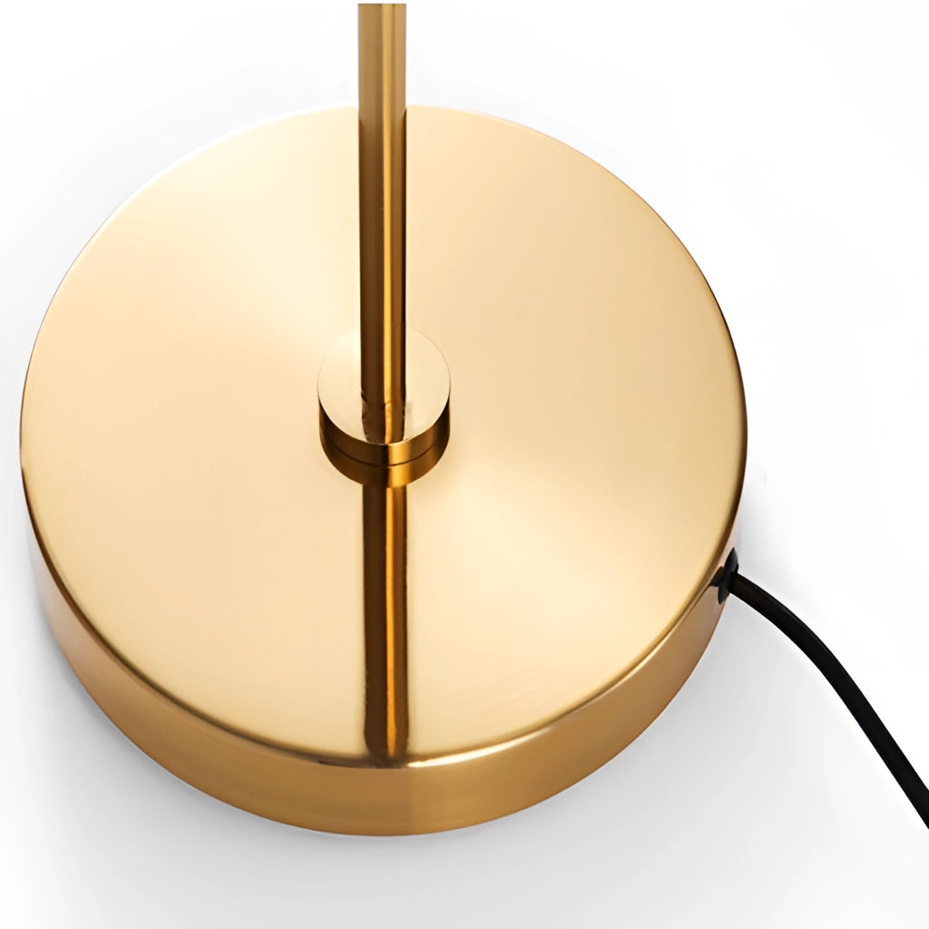 Modern floor lamp with adjustable head and plug-in installation, featuring a sleek metal and wood design, positioned beside a table adorned with artistic elements and accessories.