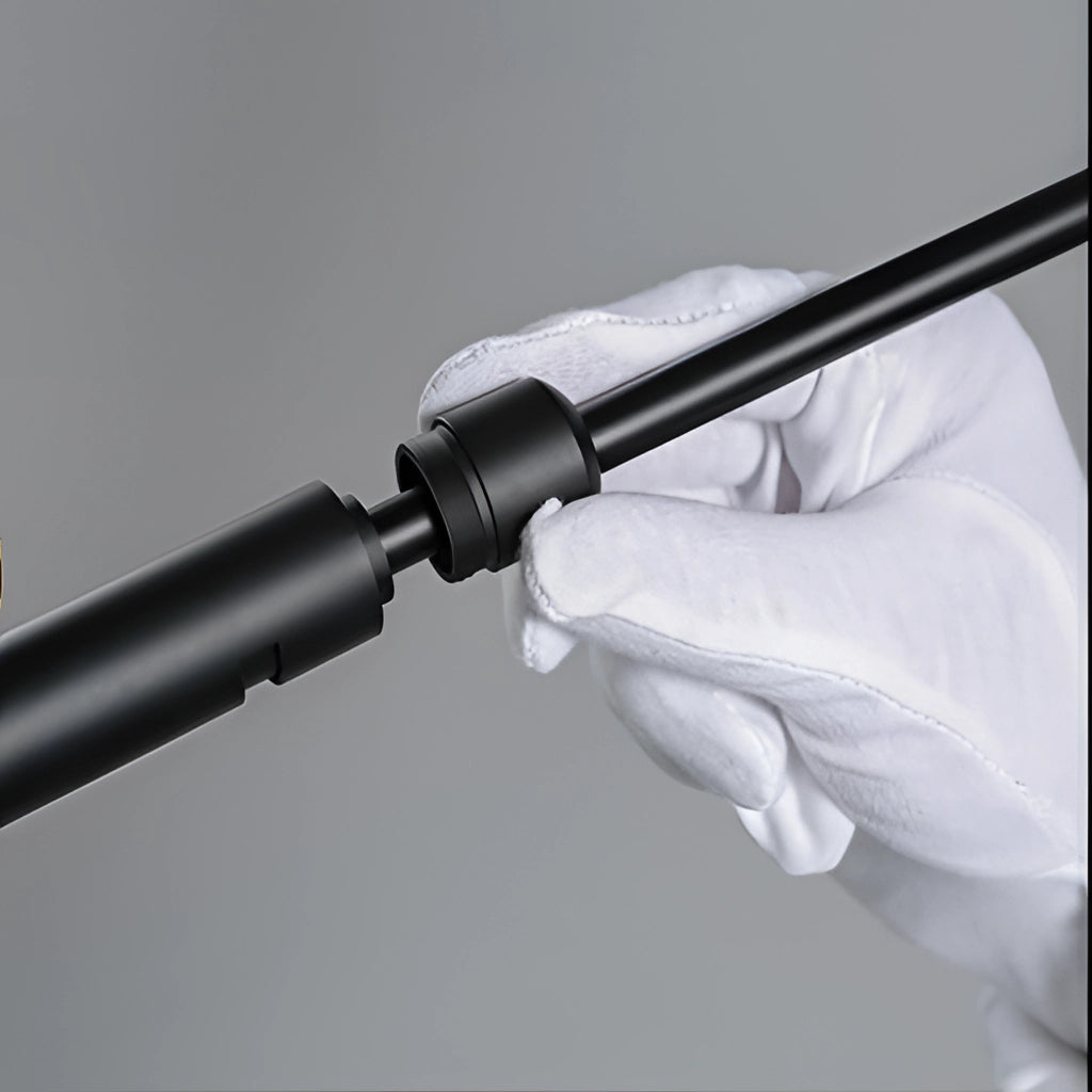 Floor lamp with a tripod base and a directional light, featuring a sleek metal design.