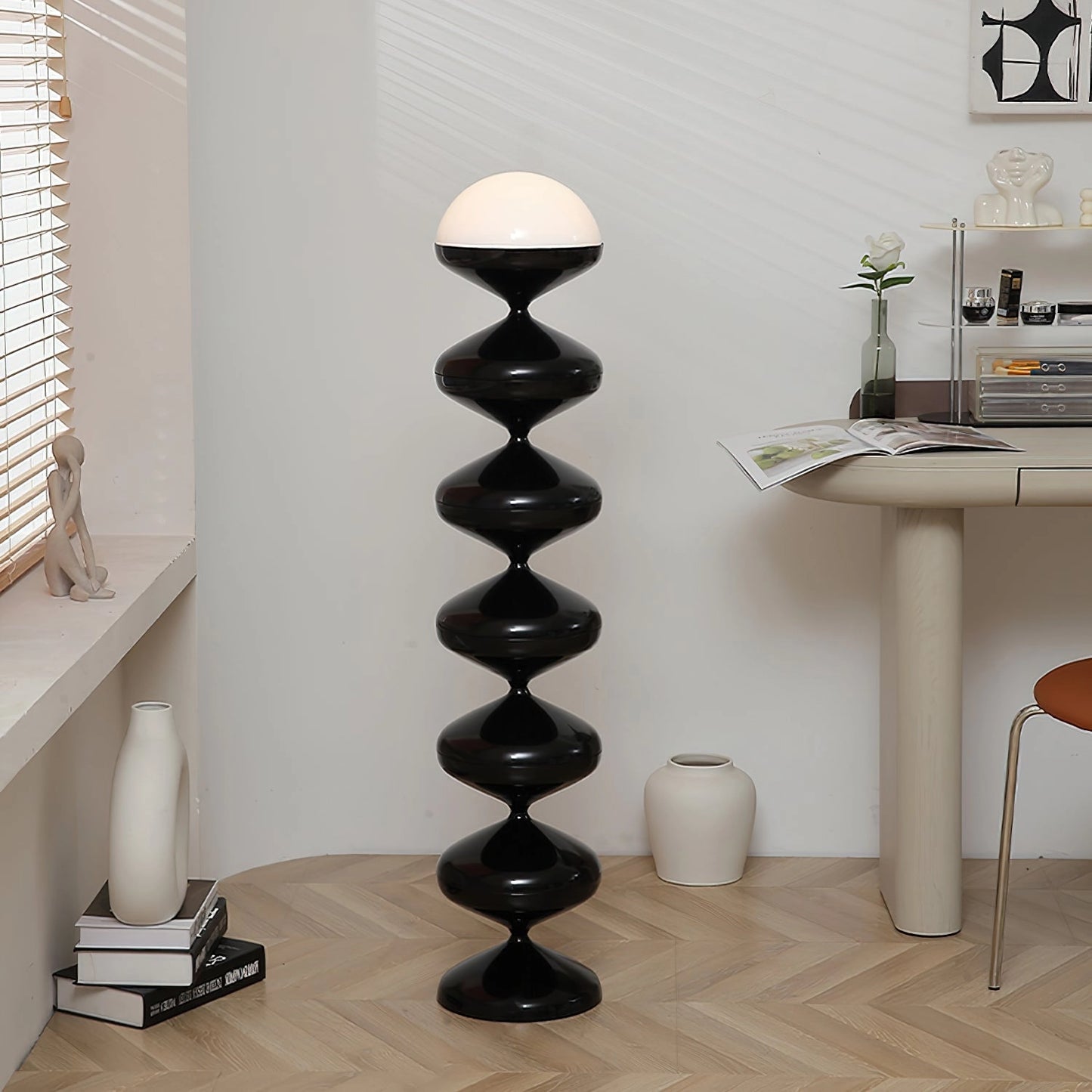 Modern floor lamp with twisted gourd design, featuring elegant white and wood elements, placed in a stylish interior setting with hardwood flooring and shelving.
