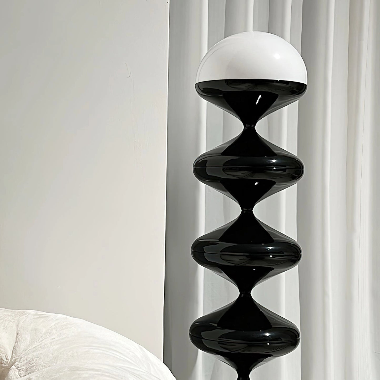 Modern elegant floor lamp with a twisted gourd design, featuring a rectangle base, wooden and metal elements, symmetrical pattern, and glass accents.