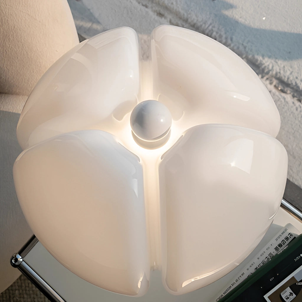 A floral design table lamp with adjustable height and LED light featuring intricate flower patterns on the lamp shade, placed on a sleek modern base.