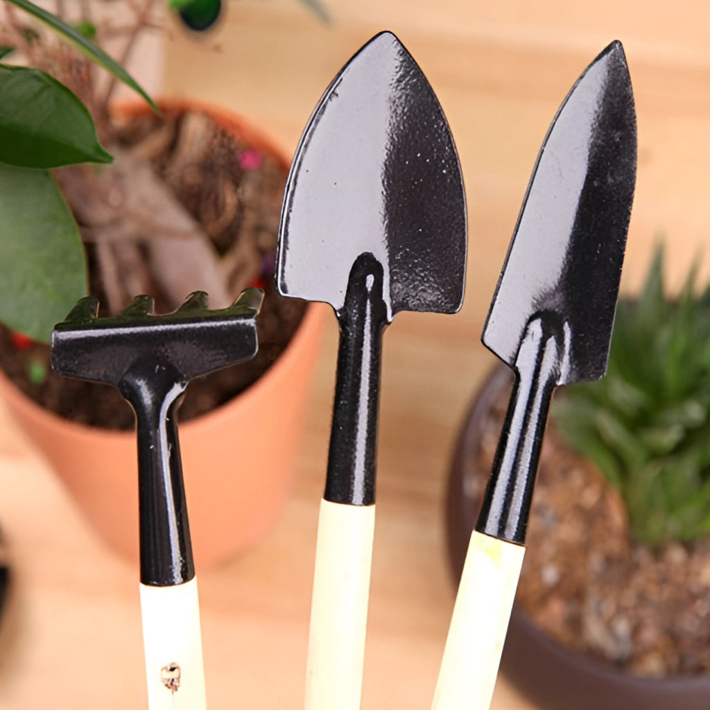 Gardening tool set with durable iron and wood handles, including various tools such as a trowel and pruner, displayed on a wooden surface with some garden plants in the background.