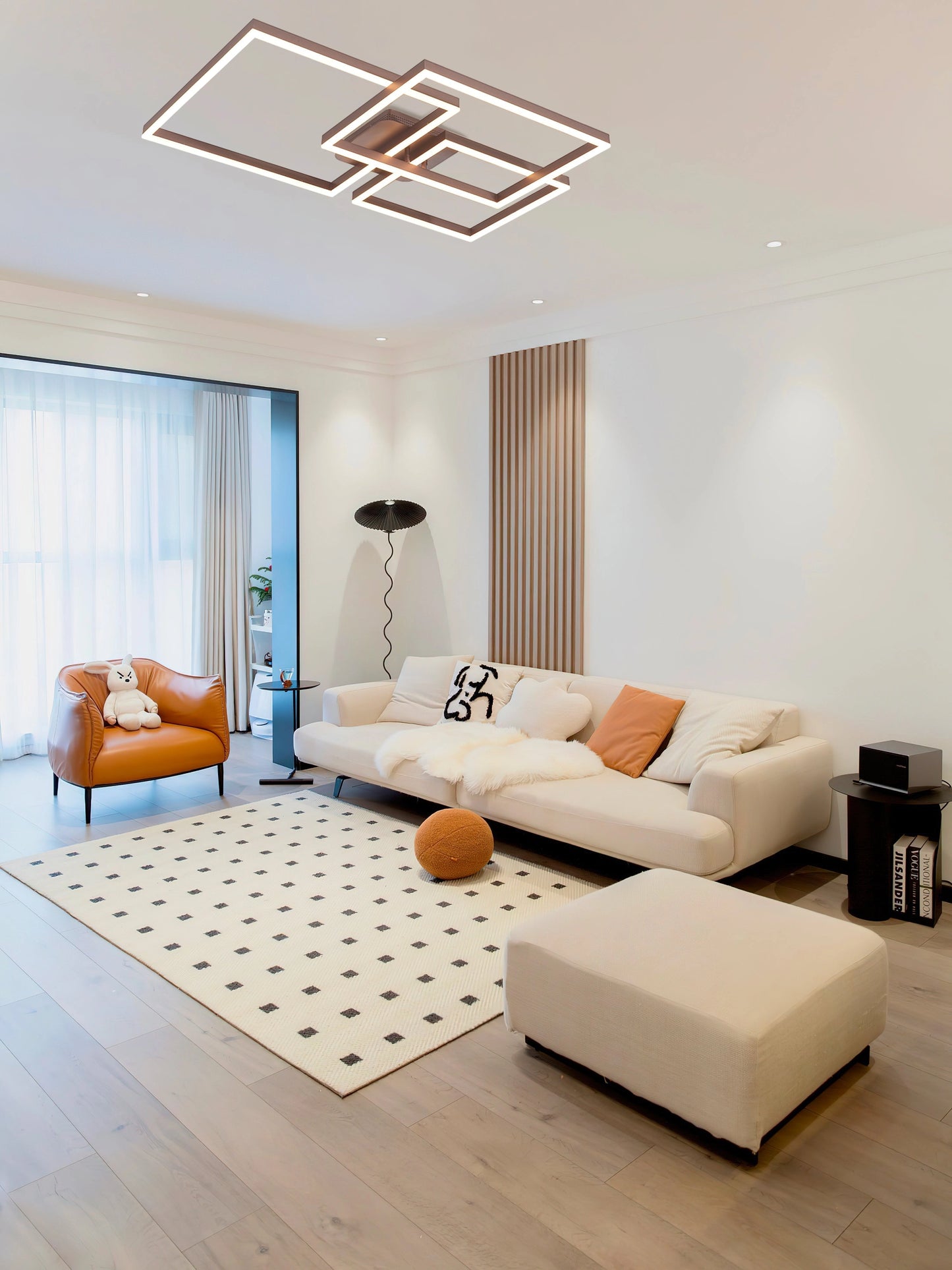 Modern Geometric Aluminum Pendant Light with LED technology hanging in a stylish beige living room with wooden flooring, a comfortable couch, and large windows.
