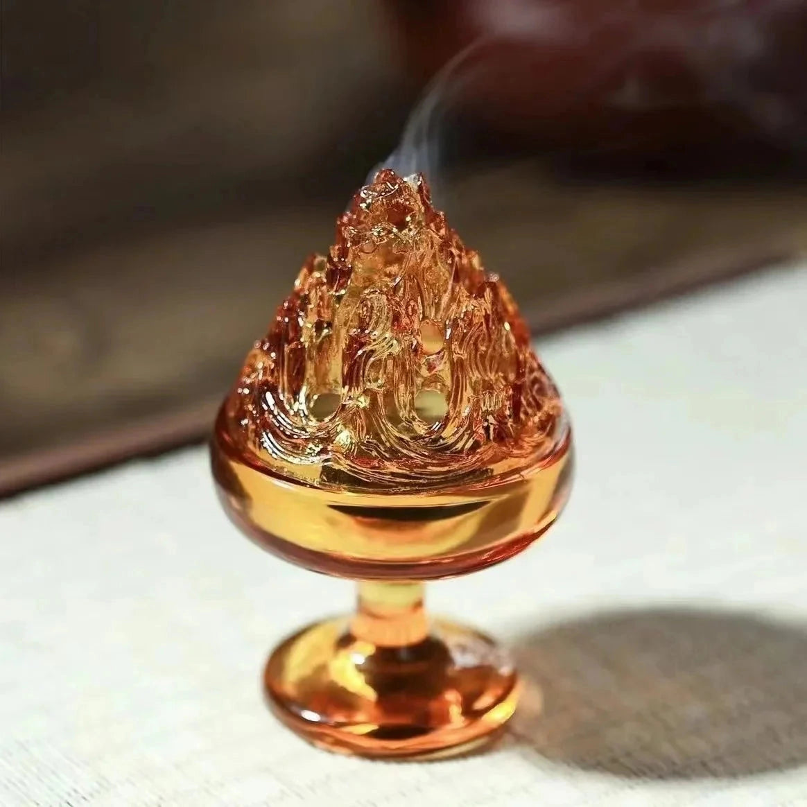 Glass incense burner with an amber hue, designed for zen home decor.