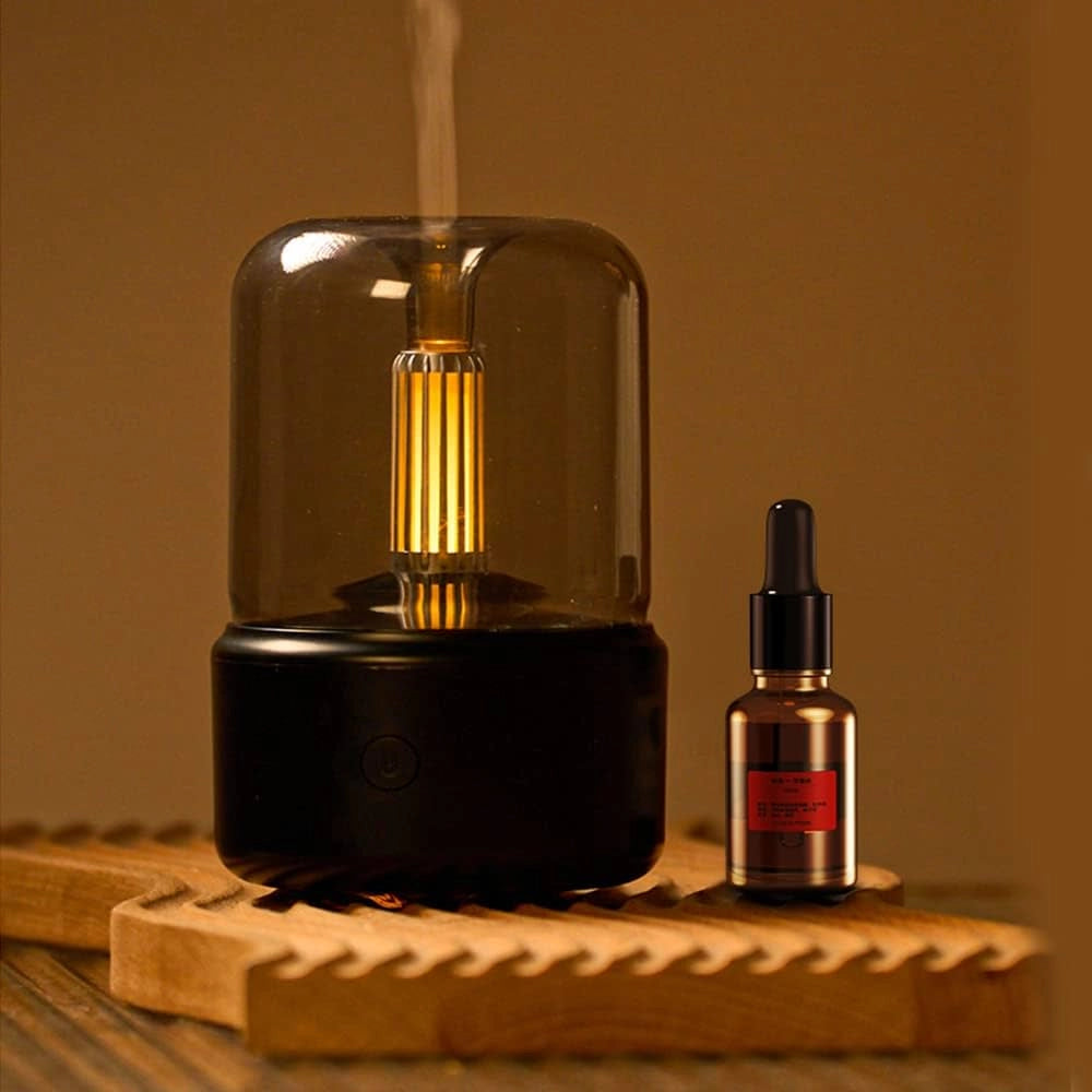Black USB LED Aromatherapy Diffuser with Candle Light Effect placed on a wooden surface.