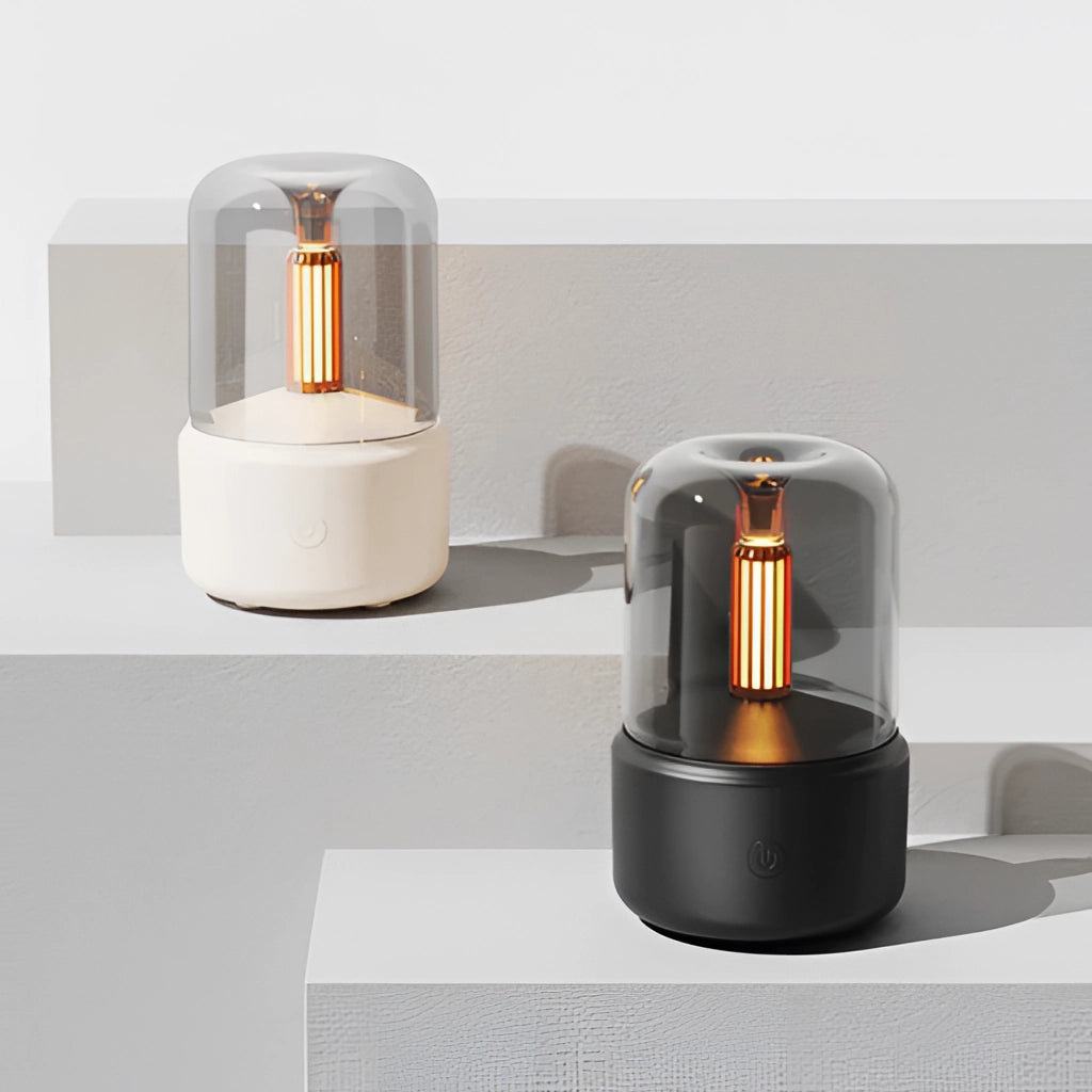 LED Aromatherapy Diffuser with Candle Light Effect on a wooden shelf, featuring a sleek cylindrical design and a soft, glowing light for a soothing ambiance in interior spaces.