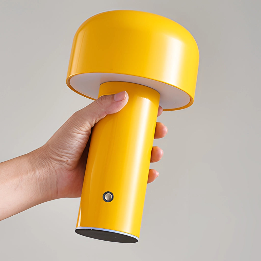 LED cordless table lamp with unique mushroom design in yellow, featuring a sleek plastic and metal build with a warm amber glow.