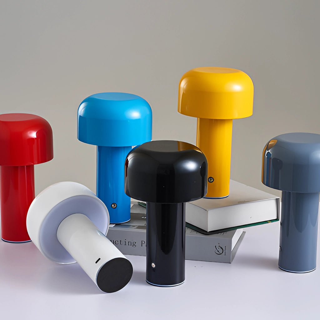 A person holding an LED cordless table lamp with a unique mushroom design.