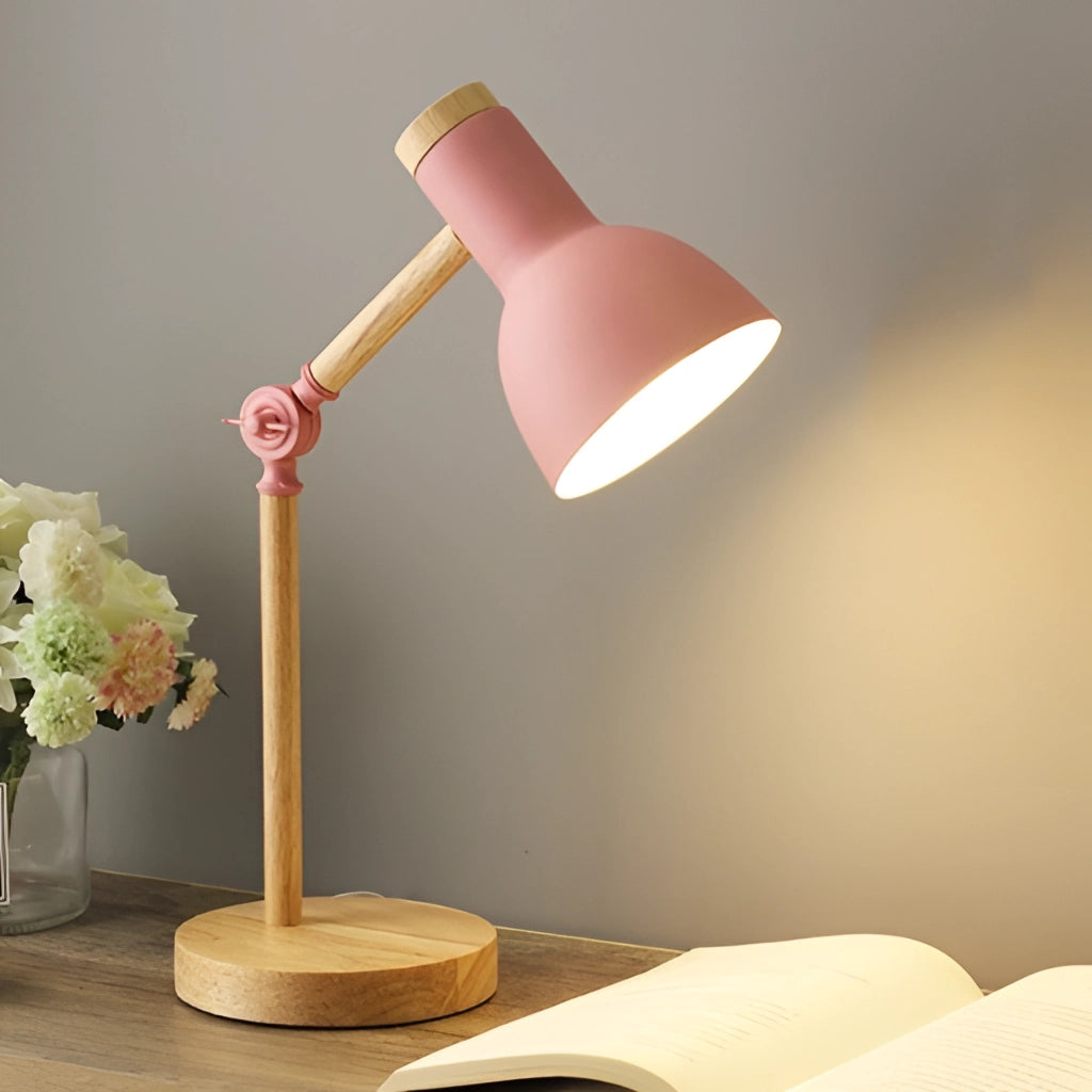LED desk lamp with Scandinavian minimalist design in rosa color, featuring three adjustable lighting options and a switch, placed on a wooden table next to a vase with flowers.