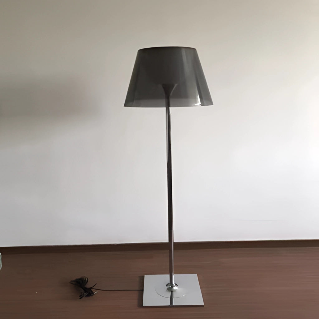 LED floor lamp with amber, clear, and gray downward shade, wooden base, metal light fixture, and hardwood flooring.