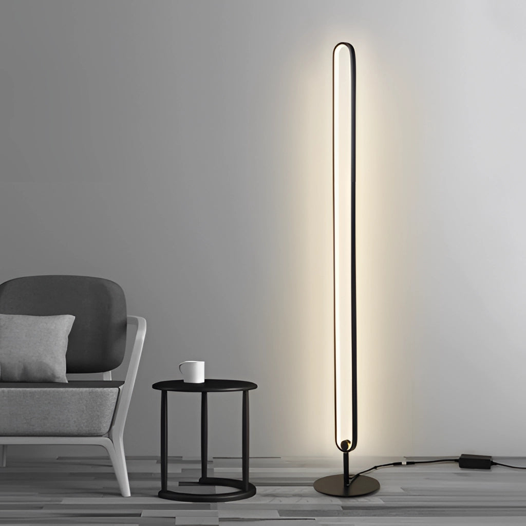 LED floor lamp with a stylish design featuring RGB multicolor and warm white lighting, placed on wooden flooring next to a chair.