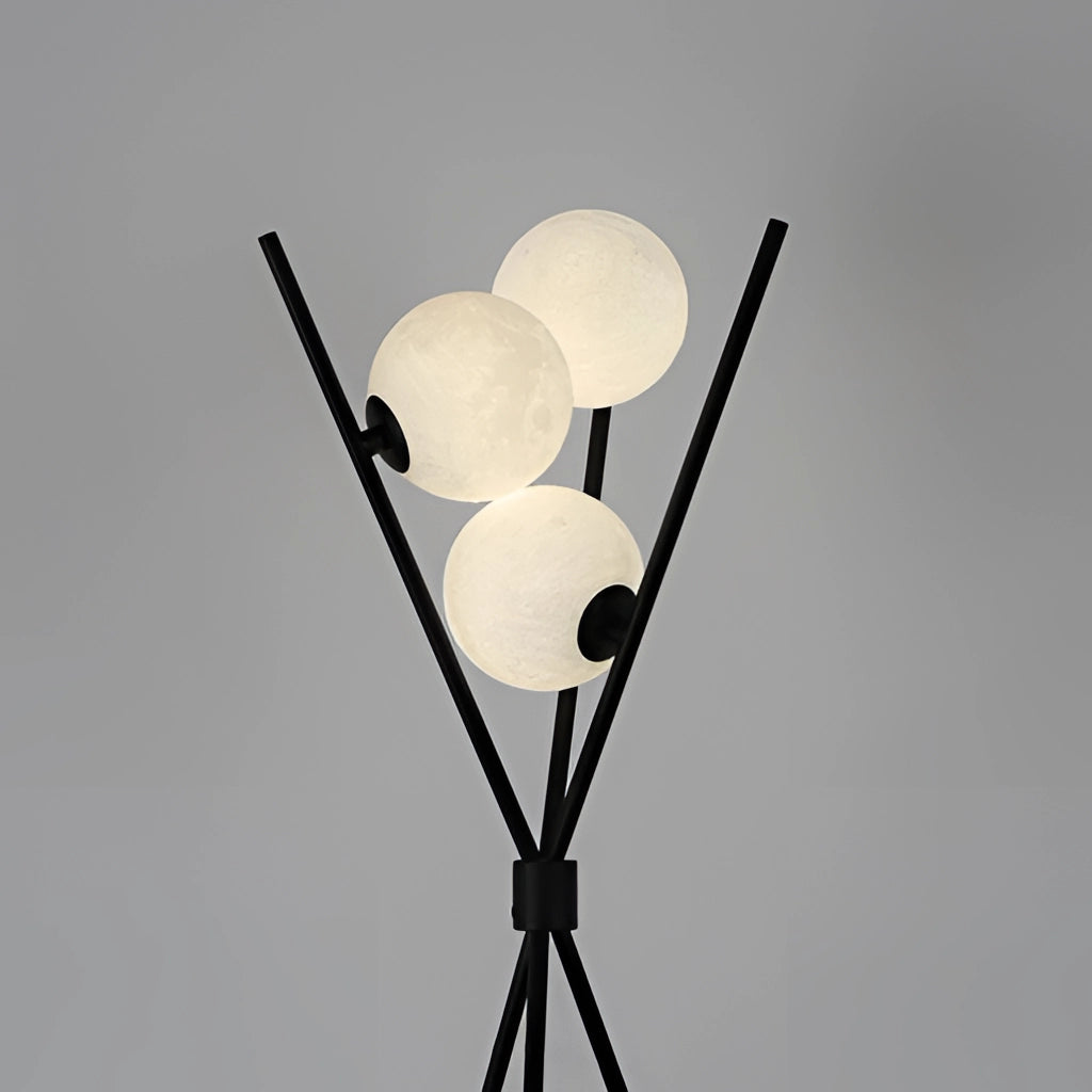 Modern LED moonlamp illuminating a living room with its spherical design, featuring a sleek metal pole and artful presentation.