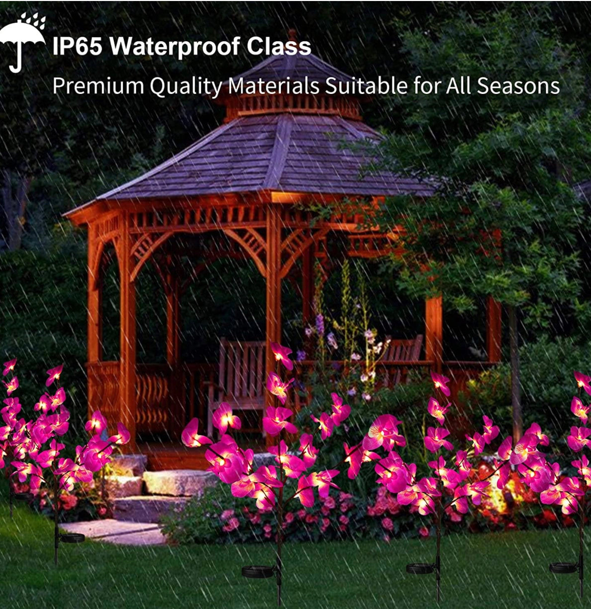 LED Solar Orchid Lights with Color Transition - Twin Pack featuring realistic magenta orchid flowers with petals, set in a garden with surrounding vegetation and a gazebo in the background.