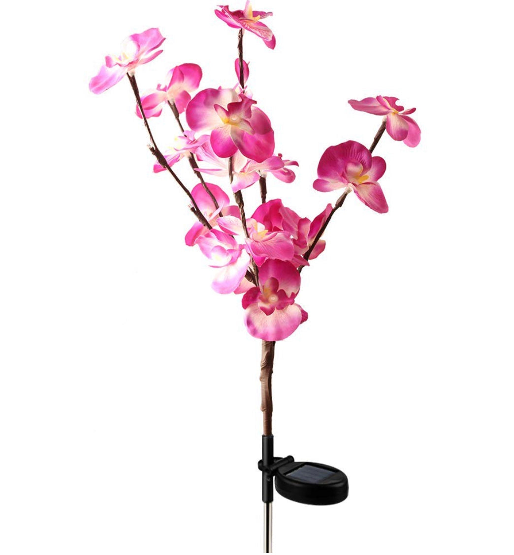 LED Solar Orchid Lights with Color Transition in 2 Pack Purple featuring vibrant artificial flowers with magenta petals, mounted on twigs, designed to resemble flowering plants.