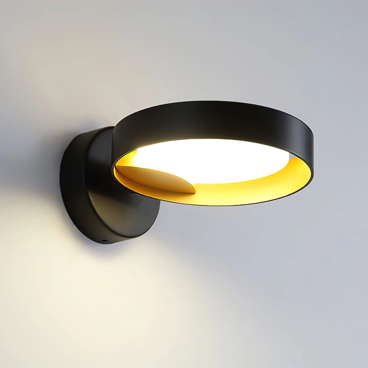Contemporary iron and acrylic LED wall light with artistic circular design, featuring a sleek and modern sconce.