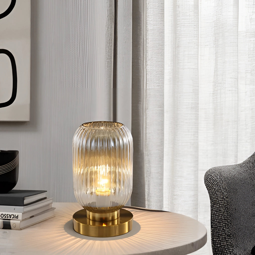 Luminescent crystal table lamp on a wooden table in a modern interior setting with metal accents and curtains in the background.