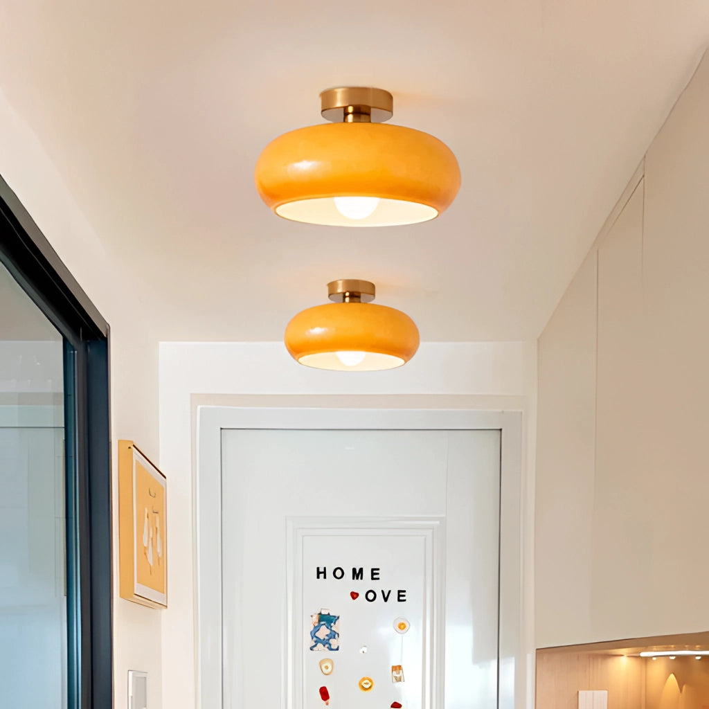 Luxury Modern Style Jaxon Glass Pendant Light chandelier with LED bulbs, featuring amber glass and sleek design, illuminating a modern interior with wooden accents and warm yellow tones.