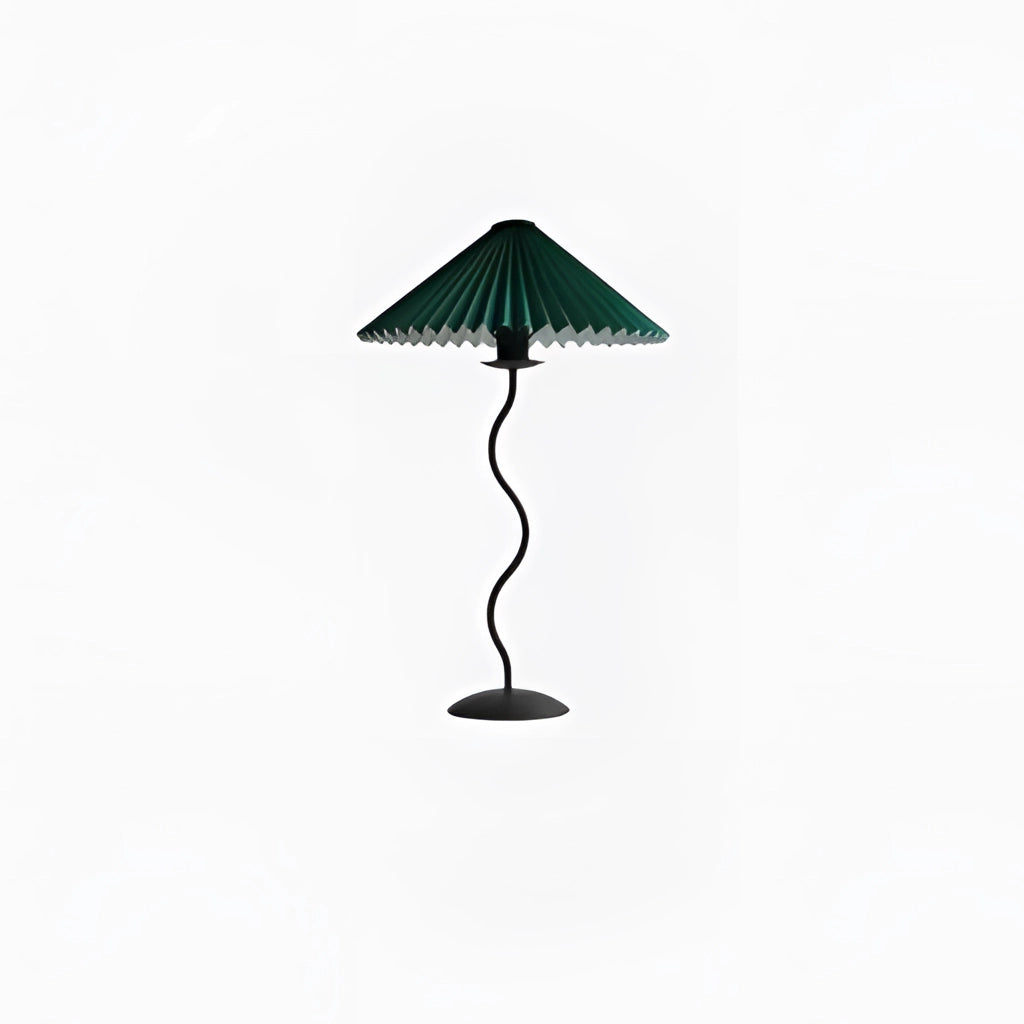 Teal metal textile pleated table lamp with a curved design, featuring a tints and shades lampshade, placed on a table next to a plant.