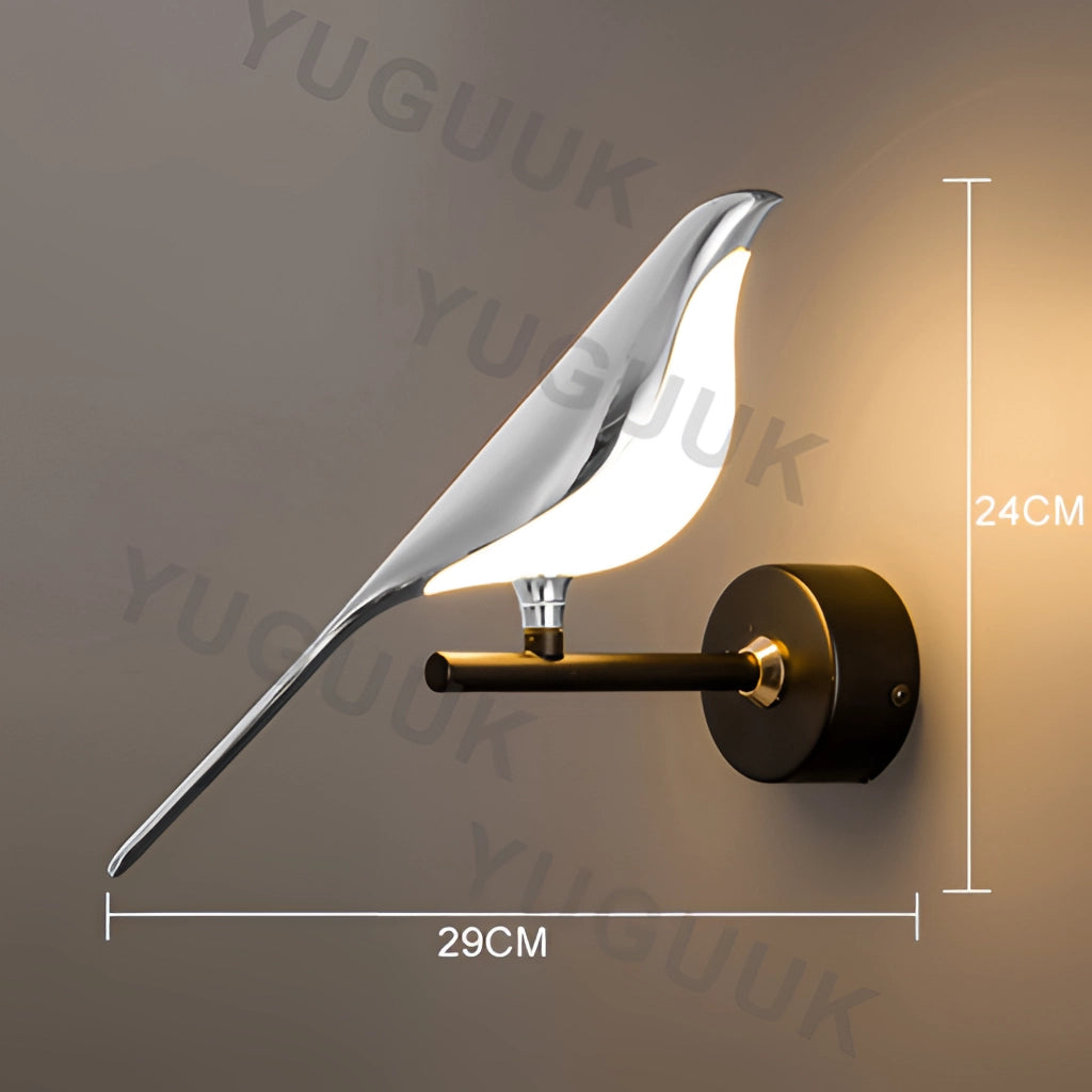 Modern rotatable wall sconce with a 360-degree lampshade, single head in silvery finish, emitting warm light.