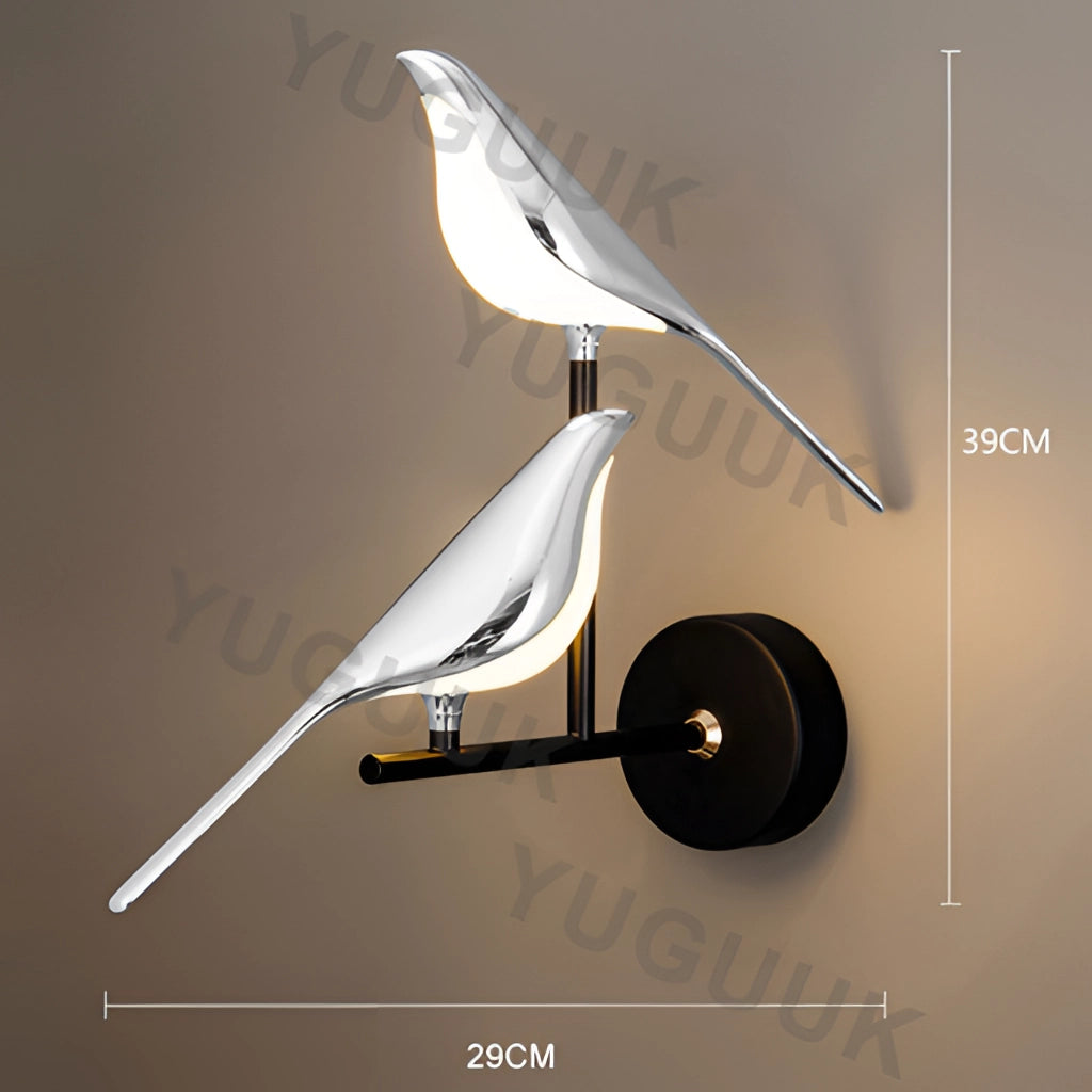 Modern rotatable wall sconce with a 360-degree gold lampshade featuring two silvery heads, emitting warm light.