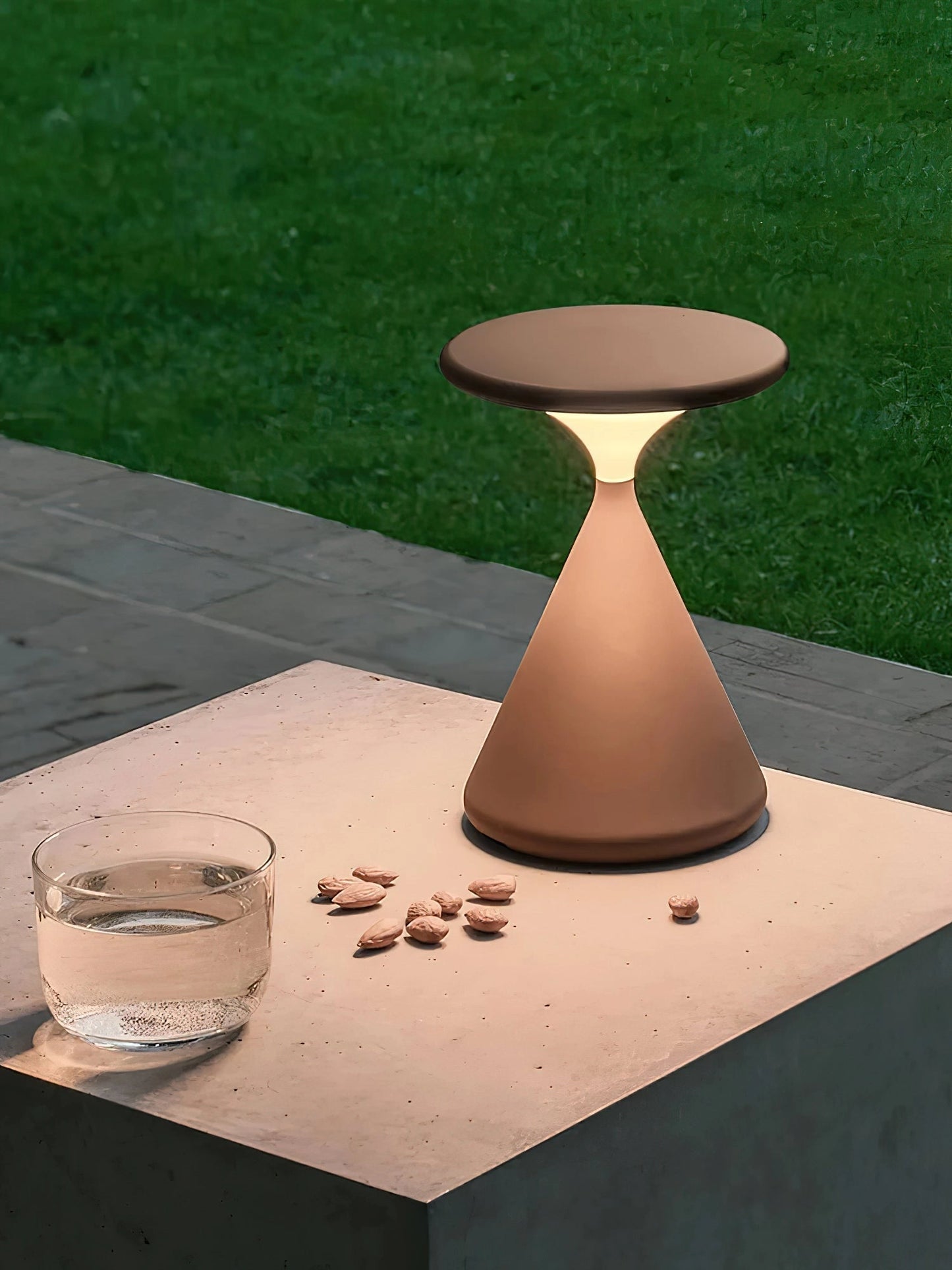 Versatile and elegant outdoor cordless lamp on a wooden table, providing portable ambiance in an outdoor setting.