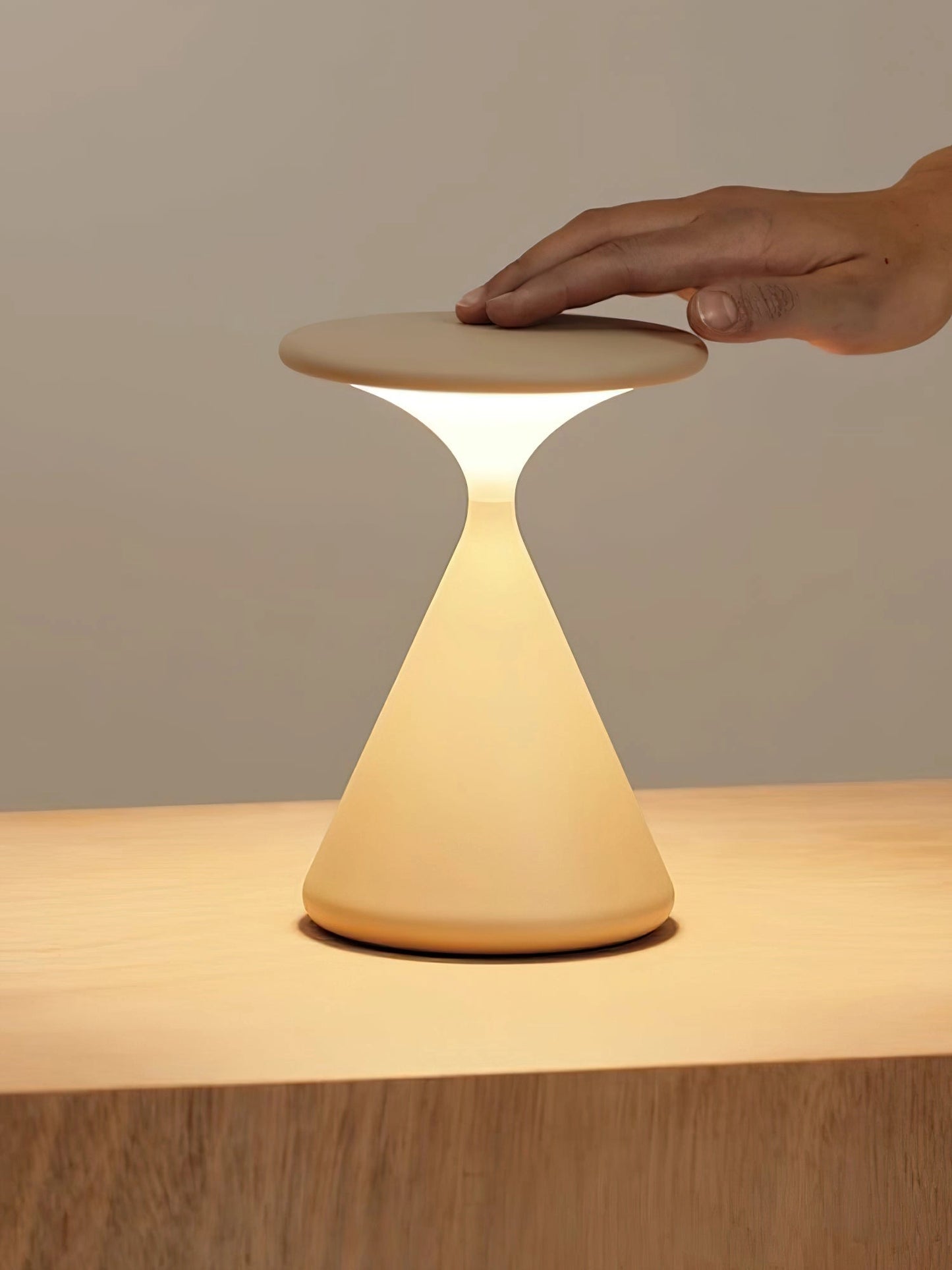 Outdoor Cordless Lamp for Portable Ambiance - Selene, Versatile and Elegant, placed on a wooden table with a chair nearby, showcasing its elegant design and sturdy build.