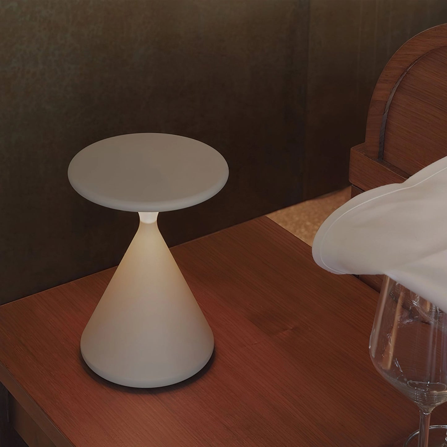 Outdoor Cordless Lamp for Portable Ambiance - Selene, placed on a wooden table in a comfortable and elegant interior setting with hardwood flooring and surrounding furniture.