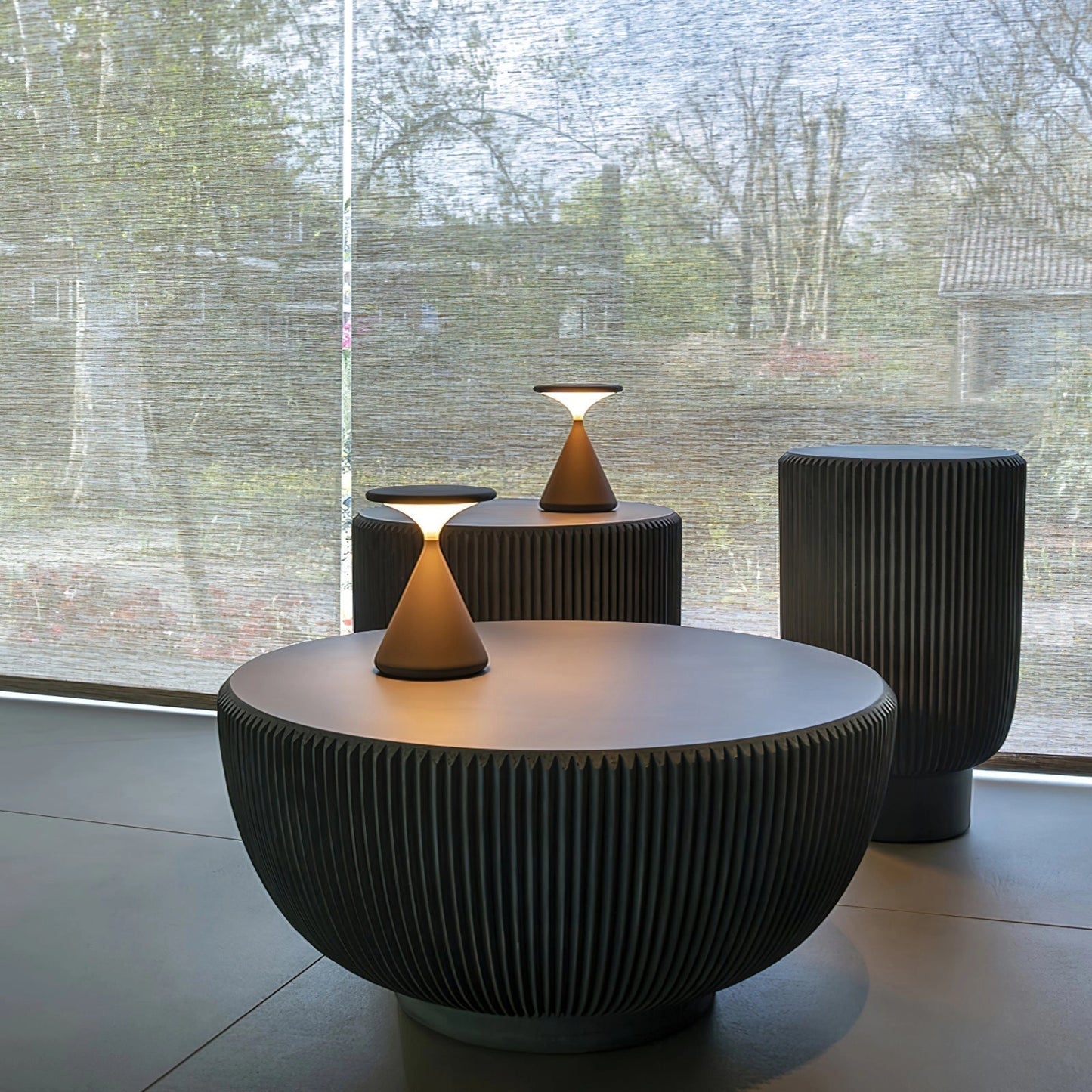 Outdoor cordless lamp on a wooden table, featuring a rectangular shade in grey, ideal for both indoor and outdoor settings, enhancing ambiance with its elegant and versatile design.