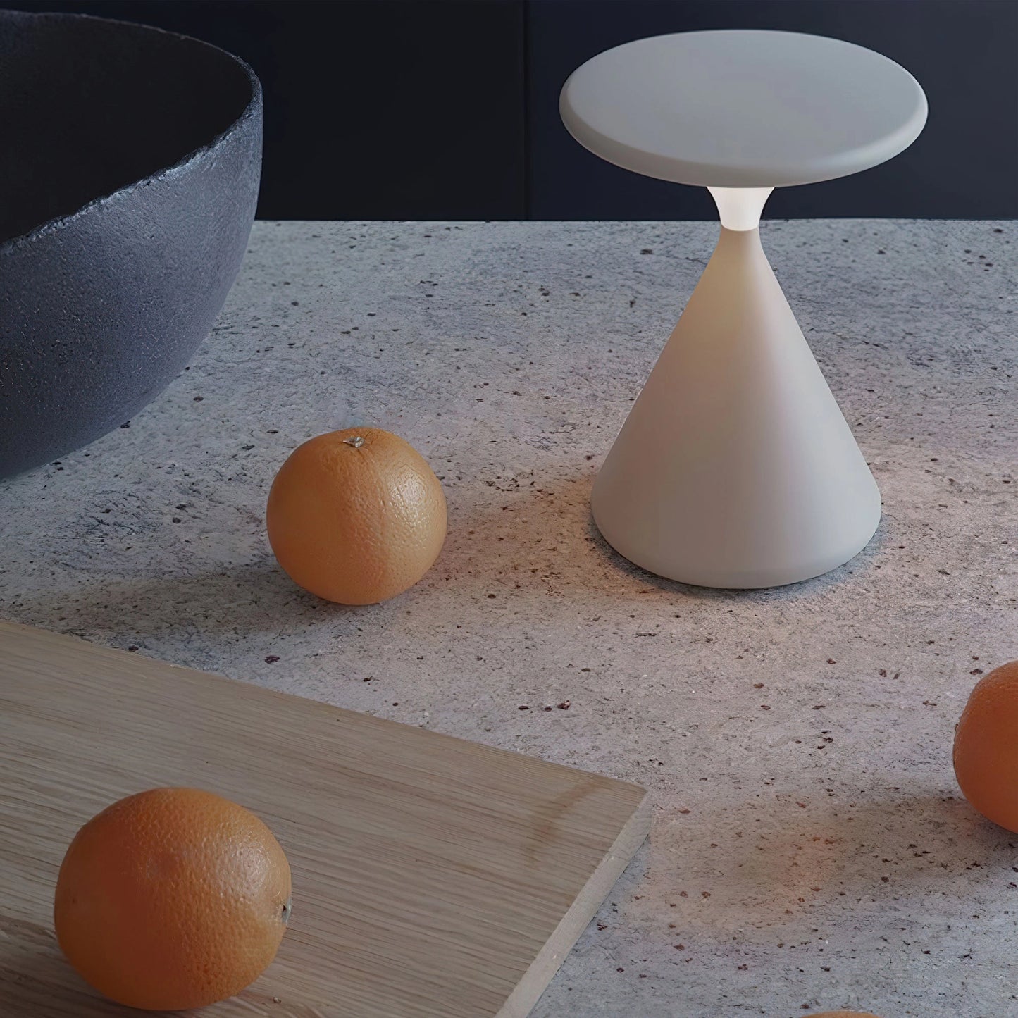 Elegant outdoor cordless lamp named Selene, with an orange hue, placed on a wooden table for portable ambiance.