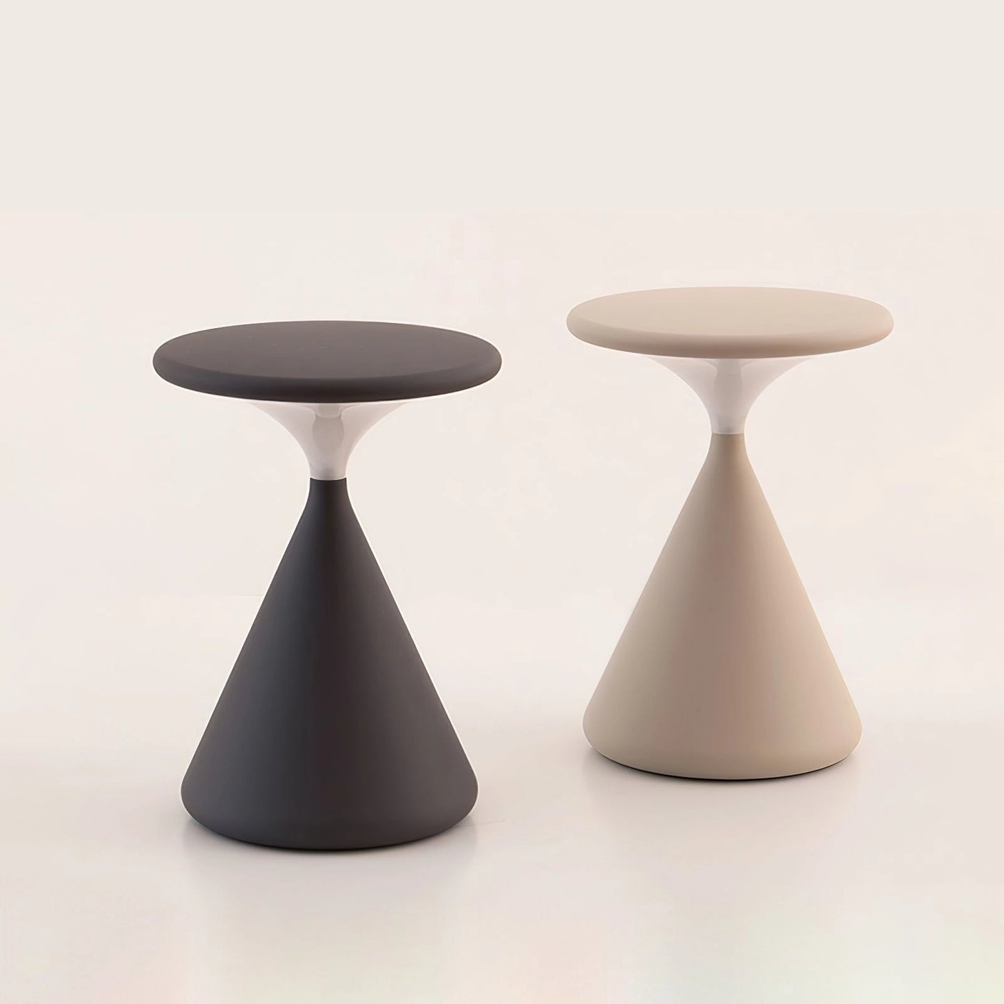 Elegant and versatile outdoor cordless lamp, Selene, on a wooden table; features a sleek, composite material design with a circular base, providing portable ambiance.