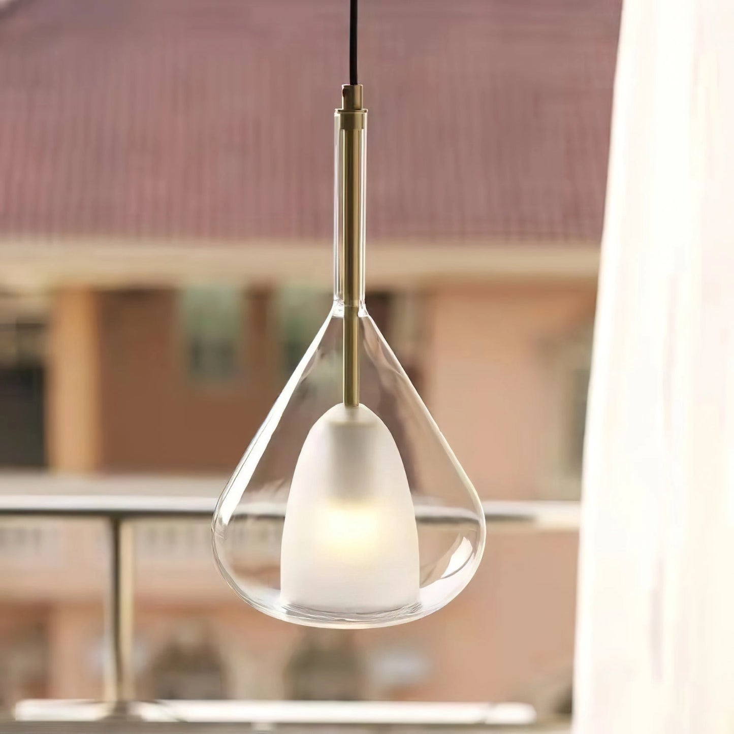 Nordic style pendant lamp with clear raindrop design, featuring a starlight effect; made of wood, glass, and metal; hanging from the ceiling.